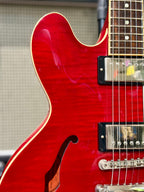Close-up of the upper bout cutaway showing the flame maple figuring and cream body binding.