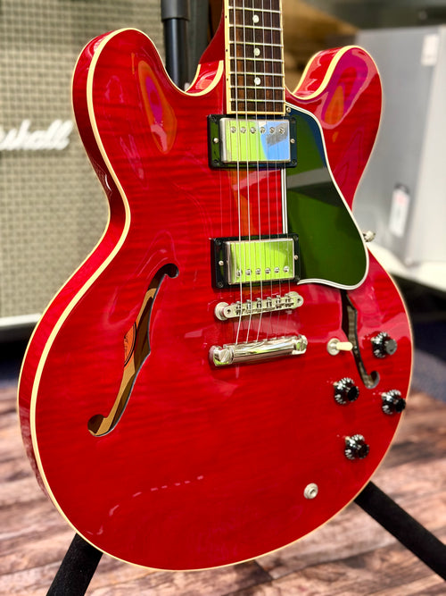Front three-quarter view of the body with both f-holes, tune-o-matic bridge, stopbar tailpiece and control knobs visible.