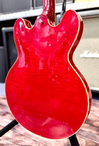 Angled view of the back of the body showing the bound edge and the curl of the flamed maple veneer under the light.