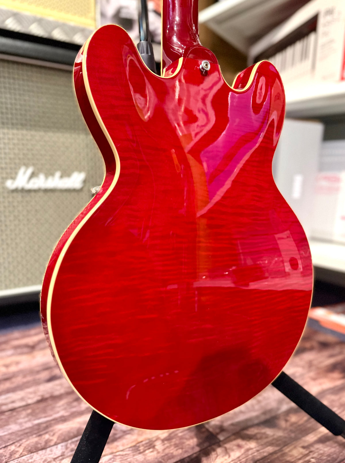 Back of the body showing the flame maple grain running through the cherry red finish and cream body binding.