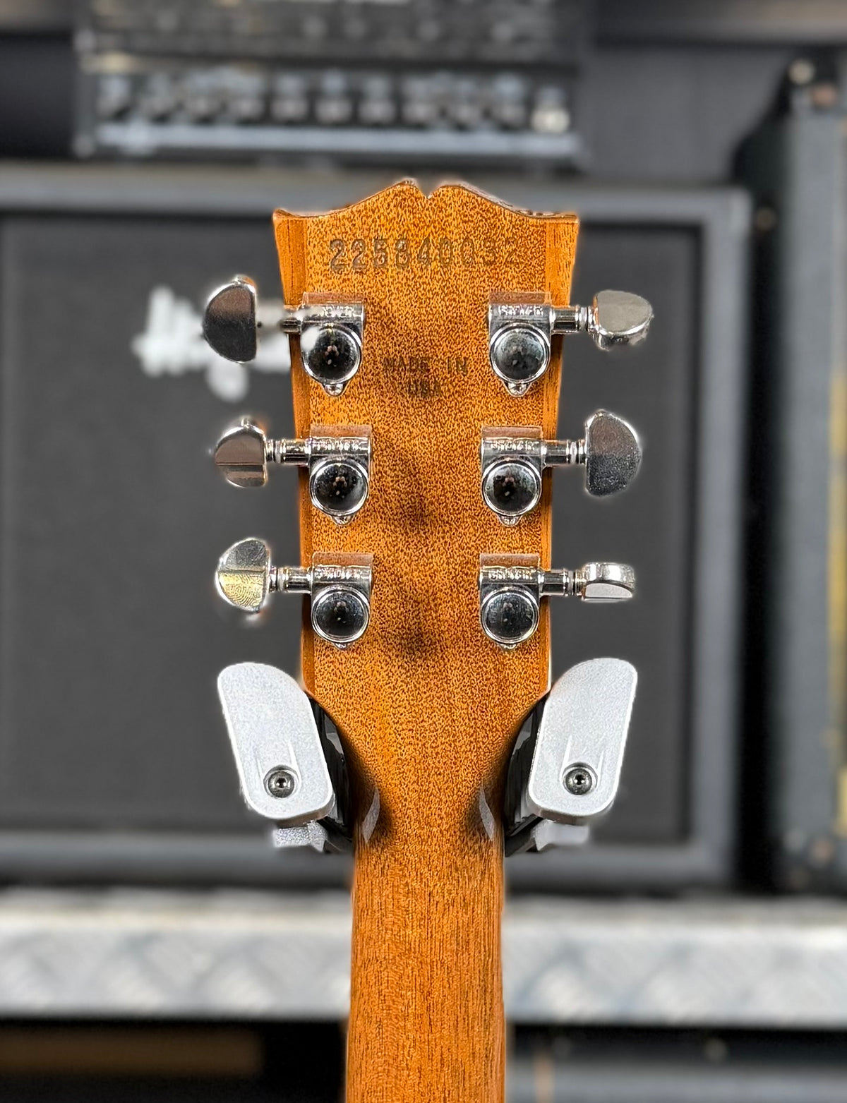 Close-up of the back of the headstock showing the factory serial number 225840032, nickel tuners and the Made in USA stamp.
