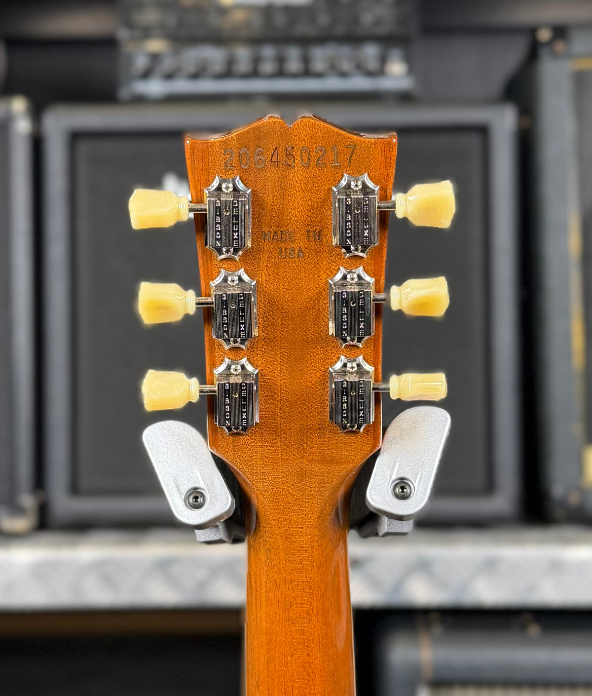 Close-up of the back of the headstock showing the factory serial number 206450217, vintage-style tuner buttons and the Made in USA stamp.