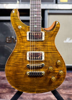 Close-up front view of the PRS McCarty 594 in Yellow Tiger, showing the flame maple top figuring, twin humbuckers, gold hardware and bird fretboard inlays.