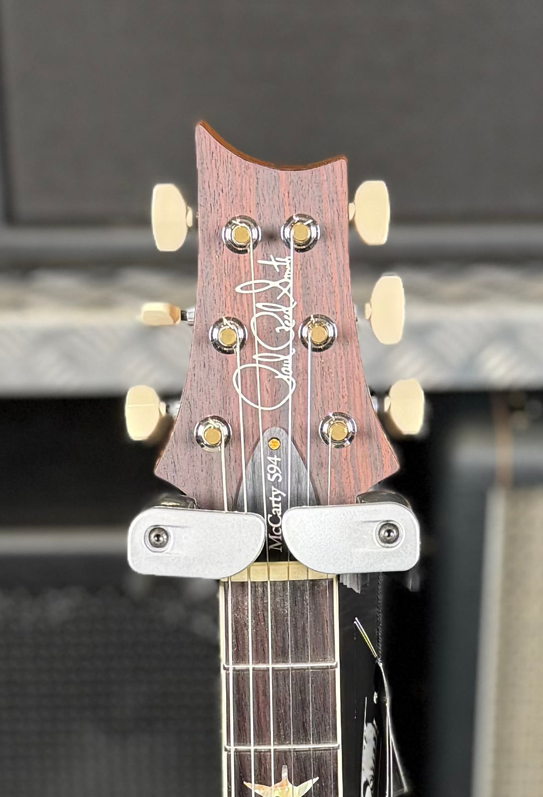 Close-up of the back of the headstock showing the Paul Reed Smith signature and the McCarty 594 model print.