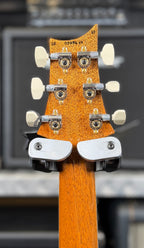 Rear of the headstock showing the mahogany finish, the handwritten factory serial number and cream-buttoned tuners.