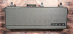 The included PRS deluxe hardcase, shown closed with its textured grey finish and the bird-flight logo on the latch panel.