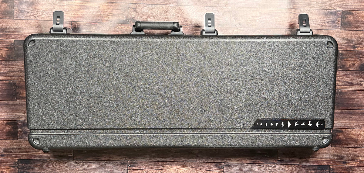 The included PRS deluxe hardcase, shown closed with its textured grey finish and the bird-flight logo on the latch panel.