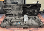 The case open and empty, showing the moulded grey plush interior and the PRS guitar documentation still in its plastic sleeve.