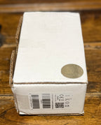 The original plain white ikon retail box with barcode sticker included with the pedal, shown closed on the wooden surface.