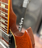 Close-up of the neck heel where it joins the body on the Gibson SG Deluxe, showing the cream body binding along the edge.