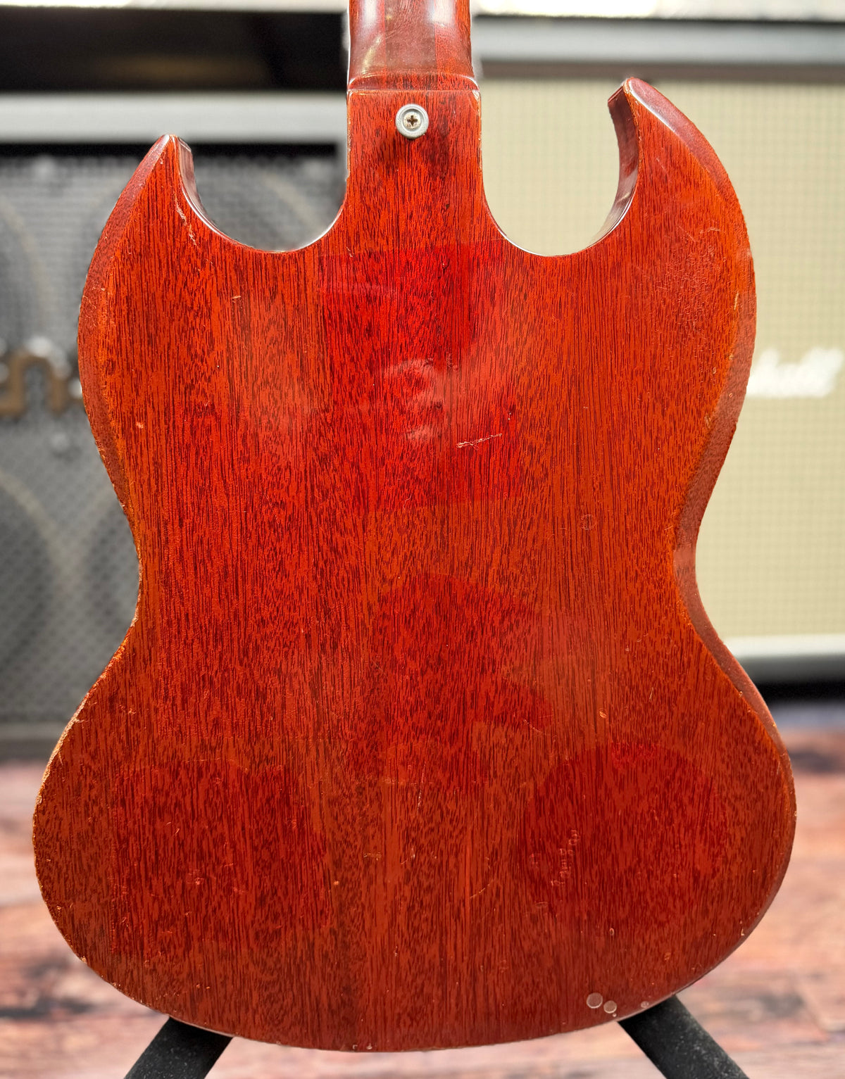 Full view of the back of the Gibson SG Deluxe body, showing the mahogany wood grain, a faint scratch near the centre and small marks near the lower edge.