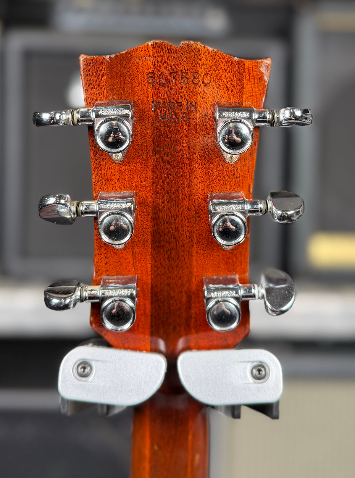 Close-up of the back of the Gibson SG Deluxe headstock showing the stamped serial number, 'Made In USA' stamp and the six tuners.