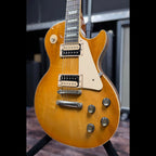 Closer three-quarter view of the body showing the two humbuckers, four control knobs and toggle switch, with the honeyburst finish and light grain figuring visible.