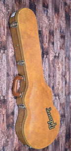 The included tan Gibson hardshell case, shown closed with its Gibson logo and leather handle.