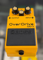 Top-down view of the full pedal and footswitch, showing the yellow casing and control layout in clean, near-mint condition.